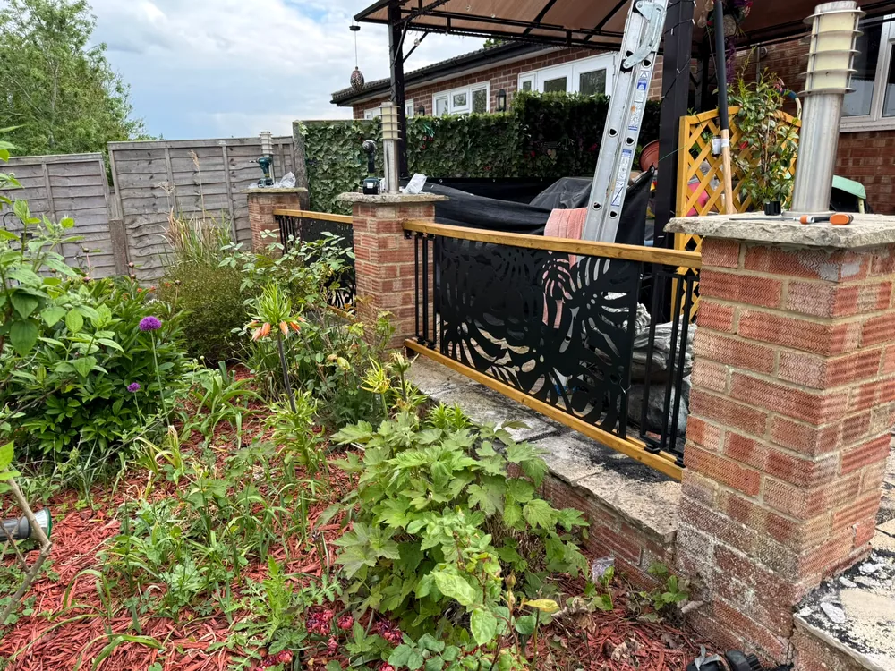 Decorative railing installed between brick pillars