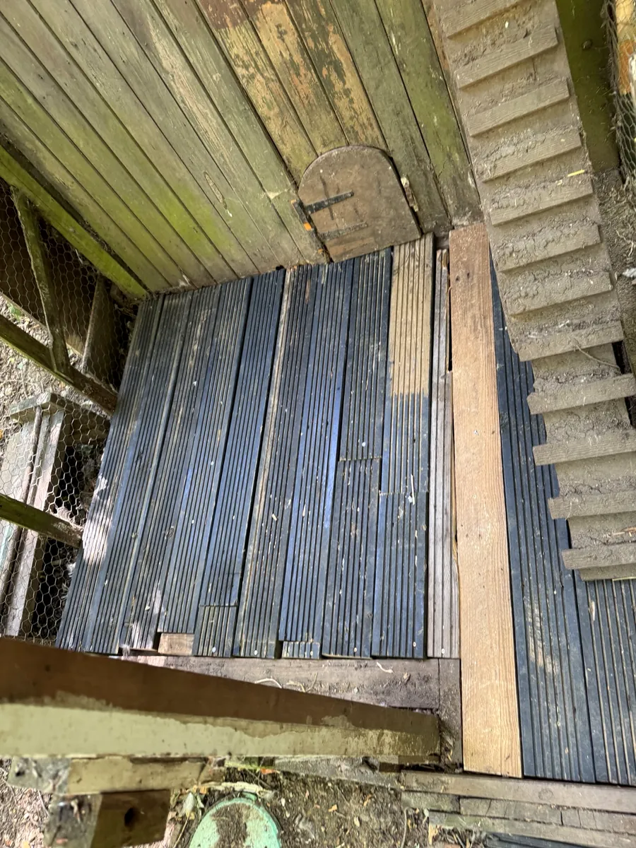 Outdoor enclosure floor repaired with dark decking boards